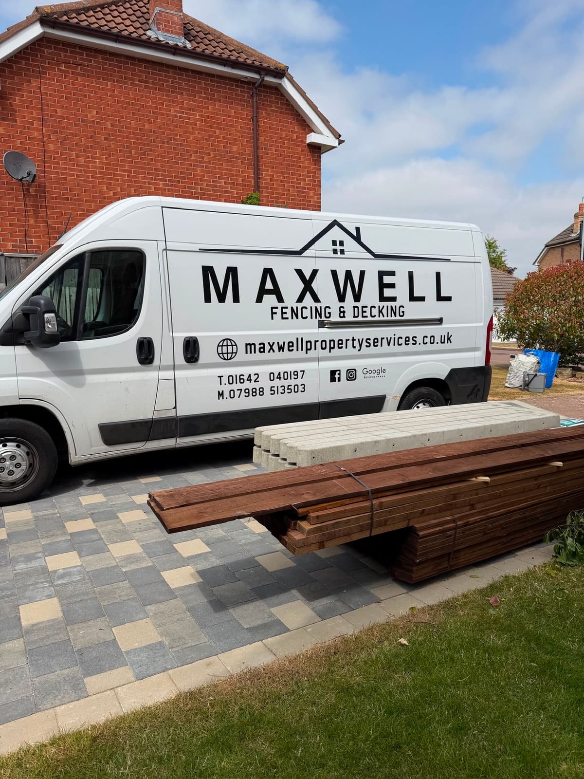 The signwritten Maxwell panel van outside a job