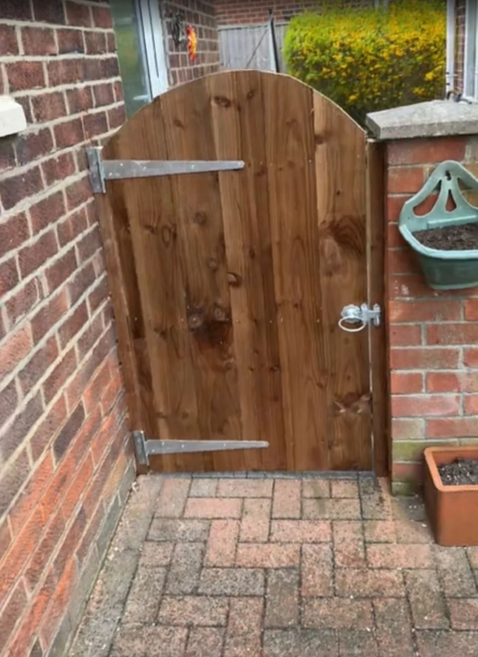 The arched timber gate from this review