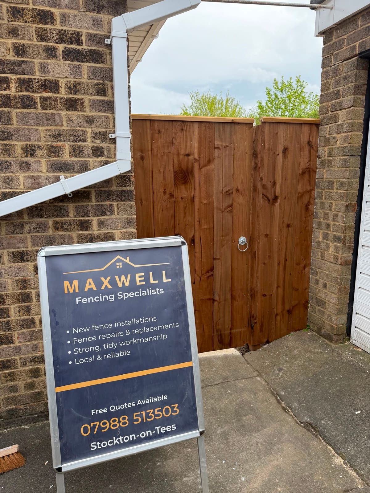 A new closeboard timber side gate with the Maxwell A-board sign outside